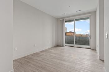 Room with glass sliding door and blinds